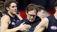 David Teague, Senior Coach of the Blues is consoled by Charlie Curnow of the Blues at three quarter time during the 2021 AFL Round 23 match between the Carlton Blues and the GWS Giants at Marvel Stadium on August 21, 2021 in Melbourn