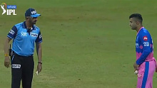 An umpire has a word with Rajasthan Royals leg-spinner Riyan Parag about his dubious side-arm action.