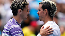 Dominic Thiem of Austria and Alex Bolt of Australia meet at the net after their second round match