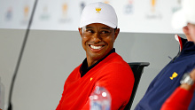 Playing Captain Tiger Woods of the United States team speaks ot his assistant captains while taking part in picking Thursday's Four-Ball Pairings 
