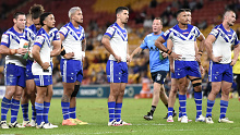 Bulldogs players await a review during their loss to the Broncos.