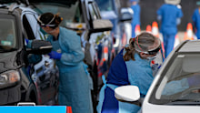 Staff collect samples at a drive-through COVID-19 testing clinic at Bondi Beach.