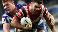 Roosters superstar James Tedesco takes a run against the Bulldogs.