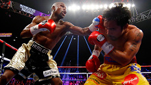 Floyd Mayweather Jr throws a punch at Manny Pacquiao during their blockbuster world title fight.