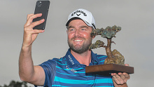 Marc Leishman celebrates with a selfie alongside the trophy after winning at Torrey Pines.