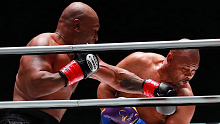 Mike Tyson lands a left hand on Roy Jones Jr.