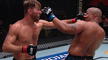 Stipe Miocic pokes Daniel Cormier in the eye during their UFC 252 heavyweight title fight.