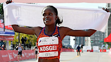 Brigid Kosgei celebrates after breaking the women's marathon world record.
