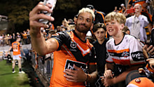 Wests Tigers captain Api Koroisau takes a selfie with a young fan at Leichhardt Oval.