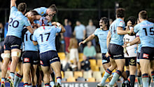 Waratahs players celebrate defeating the Crusaders at full time.