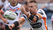 Josh Reynolds fires a pass for Wests Tigers in a pre-season trial against the Warriors.