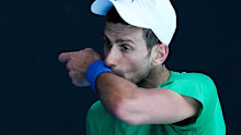 Defending men's champion Serbia's Novak Djokovic practices on Margaret Court Arena.