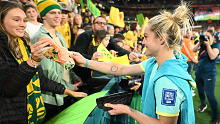 Ellie Carpenter gives her playing boot to a young fan.
