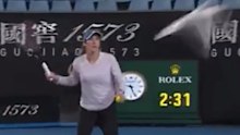 Madison Brengle swings her racquet at a seagull at Melbourne Park.