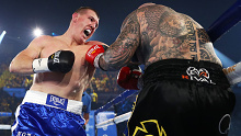 Paul Gallen punches Lucas Browne during their bout at WIN Entertainment Centre.