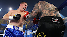 Paul Gallen punches Lucas Browne during their bout at WIN Entertainment Centre.