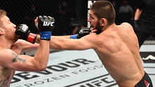 Khabib Nurmagomedov punches Justin Gaethje during their lightweight title fight at UFC 254.