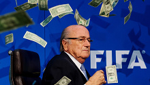 Ex-FIFA president Sepp Blatter is showered in cash by a comedian during 2015.