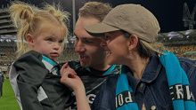 Port Adelaide's Jeremy Finlayson with his wife Kellie and their daughter.