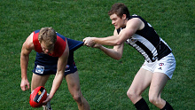 Jack Watts tackled by Heath Shaw during a Queen's Birthday clash between Melbourne and Collingwood
