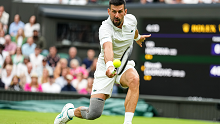 Novak Djokovic plays a backhand during his first-round match against Vit Kopriva.
