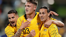 Harry Souttar of the Socceroos celebrates scoring a goal with teammates
