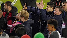 Mariners players and staff react as bottles are thrown at them by Hume City FC fans