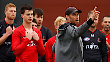 Essendon coach Ben Rutten addresses his players during a training session