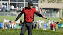 Jason Day, of Australia, waves after making a birdie putt on the 18th green of the Pebble Beach Golf Links