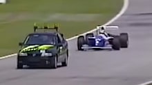 The Opel Vectra safety car leads Ayrton Senna during the 1994 San Marino Grand Prix.
