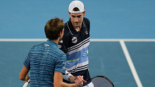 John Isner (R) shakes hands with Daniil Medvedev after their ATP Cup match.