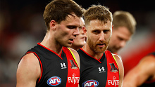 Essendon captain Dyson Heppell speaks with young gun Jordan Ridley