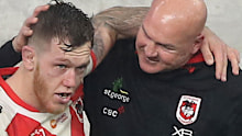 Paul McGregor shares an embrace with captain Cameron McInnes after his final game as Dragons coach. 