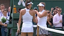 Ajla Tomljanovic and Jelena Ostapenko clash at the net.