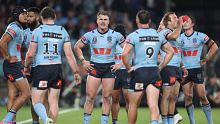 NSW Blues players react to a Queensland try during State of Origin I.