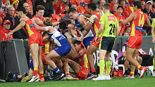 Kangaroos and Suns players threatened to go into the stands after being involved in a melee