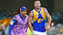 Jeremy McGovern of the Eagles leaves the ground injured