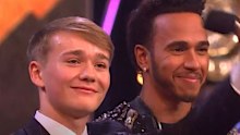 Billy Monger (left) receives his award from Lewis Hamilton.