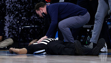 Referee Bert Smith lies on the court after collapsing during the first half of the Elite Eight game between the USC Trojans and Gonzaga Bulldogs during the NCAA Men's Basketball tournament in Indiana.