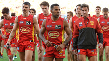 Gold Coast trudge off the field after copping a 50-point hiding at the hands of Port Adelaide.