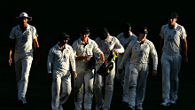 Australia depart the field after losing to India in the fourth Test.