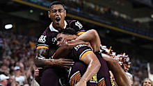 Xavier Coates celebrates a try with his Brisbane Broncos teammates.