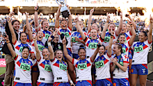 The Knights celebrate with the NRLW premiership trophy after victory in the 2022 NRLW grand final.