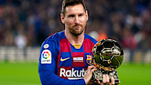  Lionel Messi of FC Barcelona holds up his sixth Ballon d'Or