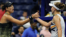 Garbine Muguruza and Barbora Krejčíková meet at the net after their US Open quarterfinal match.