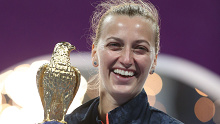 Petra Kvitova celebrates with the trophy after victory against Garbine Muguruza in the Qatar Total Open final.