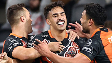 Rising Wests Tigers fullback Daine Laurie celebrates a try.