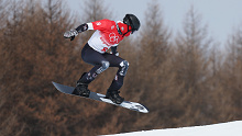 Hagen Kearney of Team United States performs a trick during the Men's Snowboard Cross Qualification on Day 6 of the Beijing 2022 Winter Olympics.