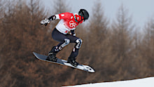 Hagen Kearney of Team United States performs a trick during the Men's Snowboard Cross Qualification on Day 6 of the Beijing 2022 Winter Olympics.