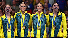 From left: Mollie O'Callaghan, Shayna Jack, Emma McKeon and Meg Harris sing the Australian national anthem after winning relay gold in Paris.